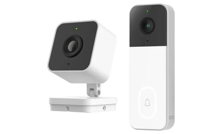 Two white smart home security devices: a cube-shaped camera and a doorbell camera.