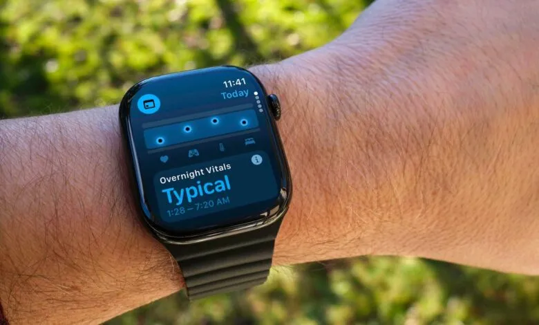 Close-up of a smartwatch displaying overnight vital signs data on a wrist.