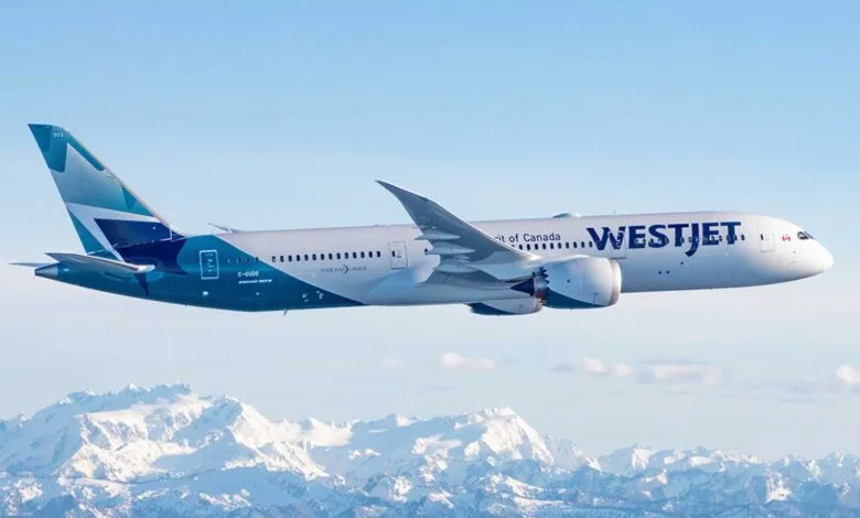 WestJet Boeing 787 Dreamliner airplane flying over snow-capped mountains.