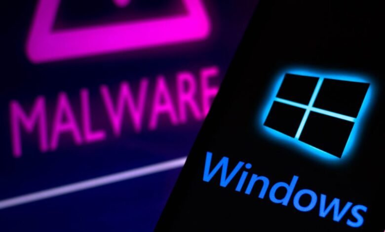 The Windows logo glows blue next to the word MALWARE in pink neon.