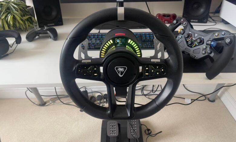 Gaming steering wheel with pedals and controllers on a desk.