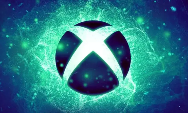 The glowing Xbox logo is centered against a dark blue and green abstract background with shimmering particles.