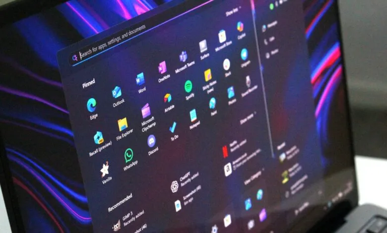 Close-up of a laptop screen displaying the Windows 11 Start menu with various app icons.
