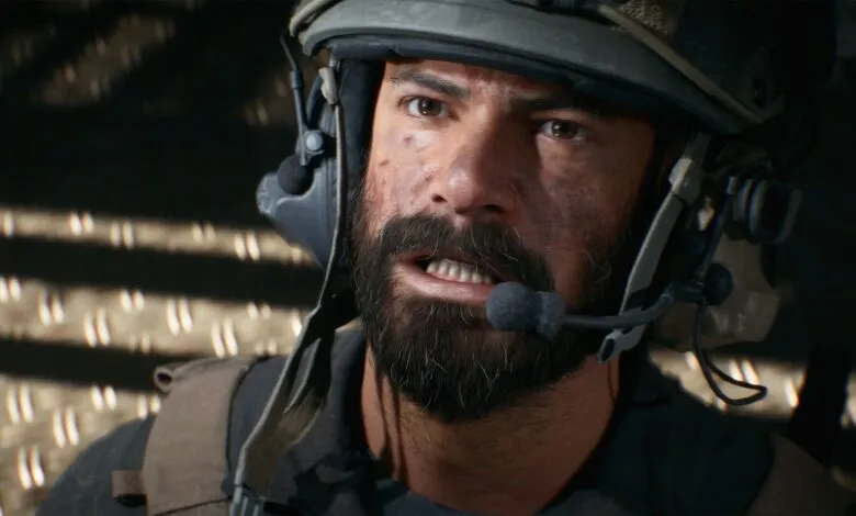 Close-up of a soldier's face wearing a tactical helmet and headset, with dirt smudges and a determined expression.