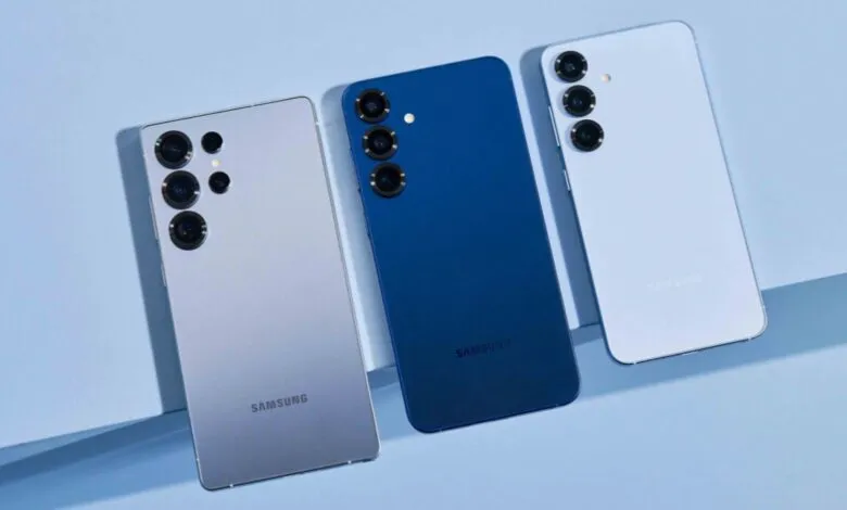 Three Samsung smartphones in silver, blue, and light purple arranged on a light blue surface.