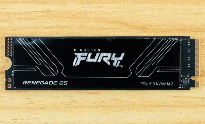 Kingston Fury Renegade G5 PCIe 5.0 NVMe M.2 SSD on a wooden surface.