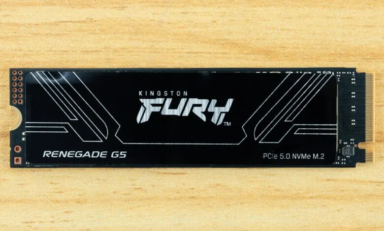 Kingston Fury Renegade G5 PCIe 5.0 NVMe M.2 SSD on a wooden surface.