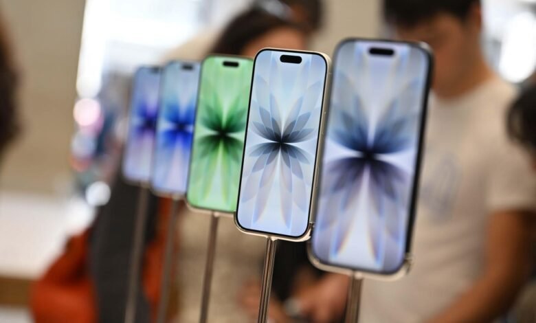 A row of iPhones displayed with colorful abstract wallpapers.