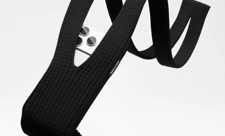 Black knitted phone strap with an iPhone peeking through