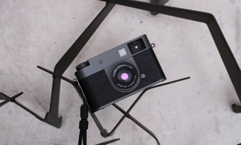 Black Fujifilm camera resting on a geometric metal stand.