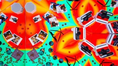 A vibrant, kaleidoscopic arrangement of Polaroid cameras, game cards, dice, and sunglasses.