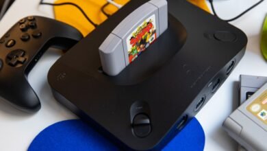 Black Nintendo 64 console with a Pokemon Snap cartridge inserted and a controller.