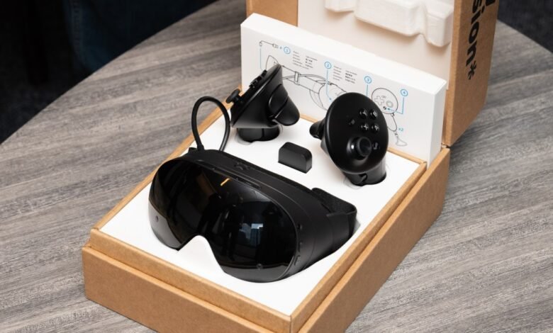 Black VR headset and controllers in an open box with instructions.