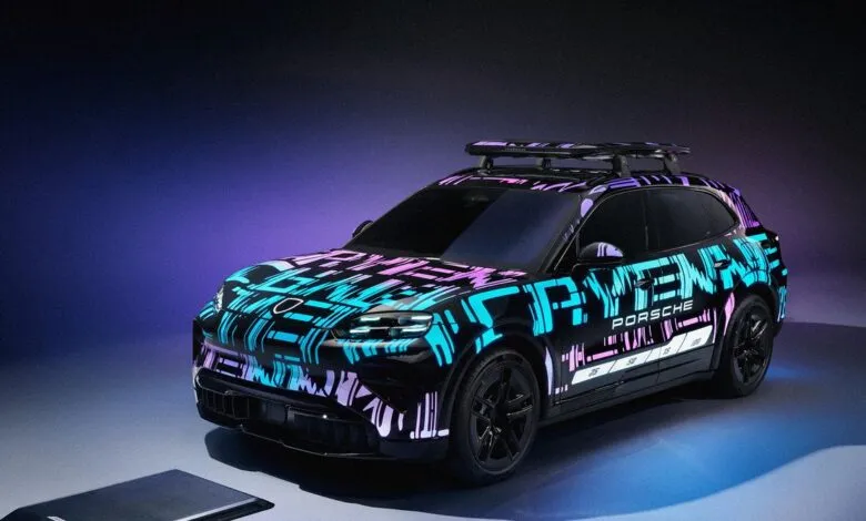 Porsche SUV with vibrant neon geometric wrap and roof rack