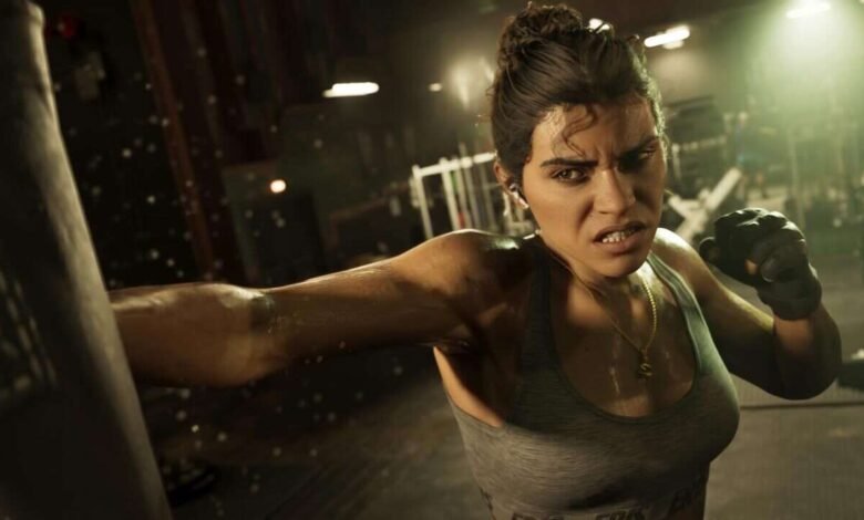A determined woman in boxing gloves throws a punch in a dimly lit gym.