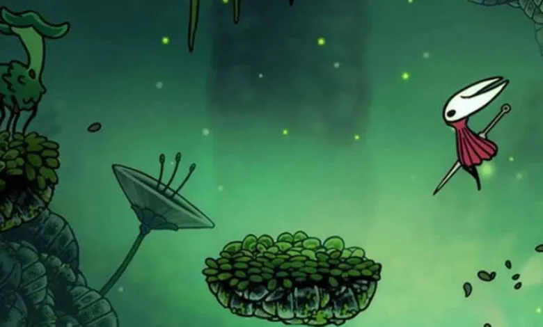 Hornet from Hollow Knight jumps through a lush, green, bioluminescent environment.
