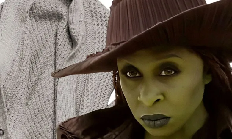 Idina Menzel as Elphaba in Wicked, wearing a hat and green makeup.