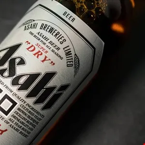 Close-up of an Asahi Super Dry beer bottle showing the label details.