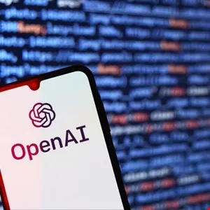 Smartphone displaying the OpenAI logo against a blurred code background.