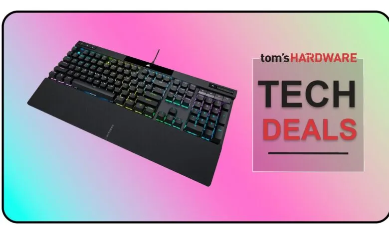 A black mechanical keyboard with RGB lighting and a wrist rest, set against a gradient background.