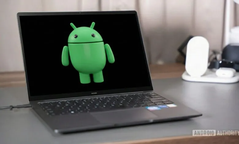 Laptop displaying the Android robot on a black screen.