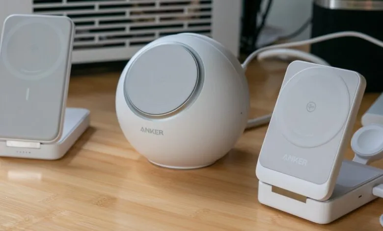 Anker wireless charging stands and a spherical charger on a wooden desk.