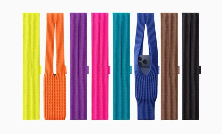 A collection of knitted phone sleeves in various bright colors, including yellow, orange, purple, pink, teal, blue, brown, and black.