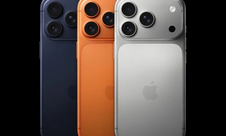 Three iPhones in blue, orange, and silver colors displayed side-by-side.