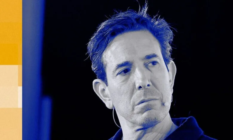 Close-up portrait of Bradley Tusk with blue and yellow abstract background.