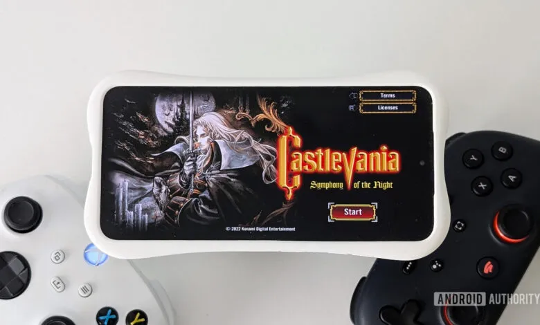 Castlevania: Symphony of the Night game title screen on a phone with controllers.