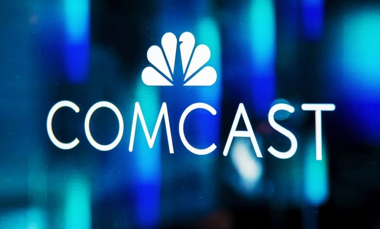 Comcast logo, white text and peacock symbol, on a blue background.
