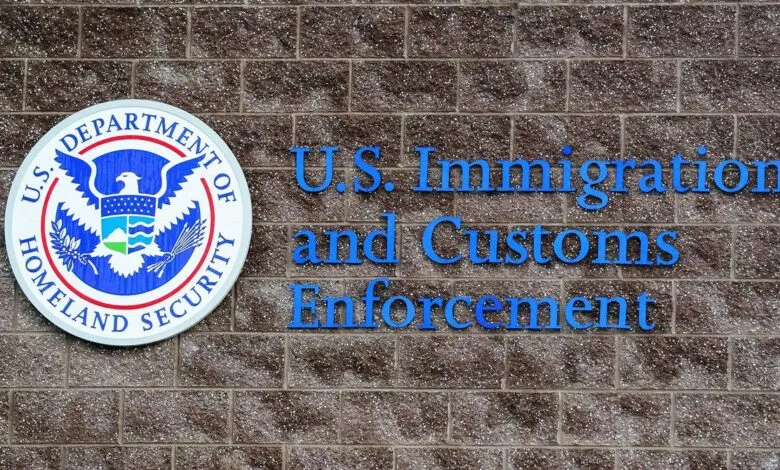 U.S. Immigration and Customs Enforcement logo and nameplate on a brick wall.