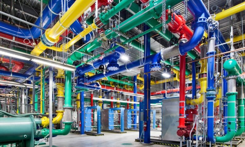 Colorful pipes and machinery in a data center cooling system.