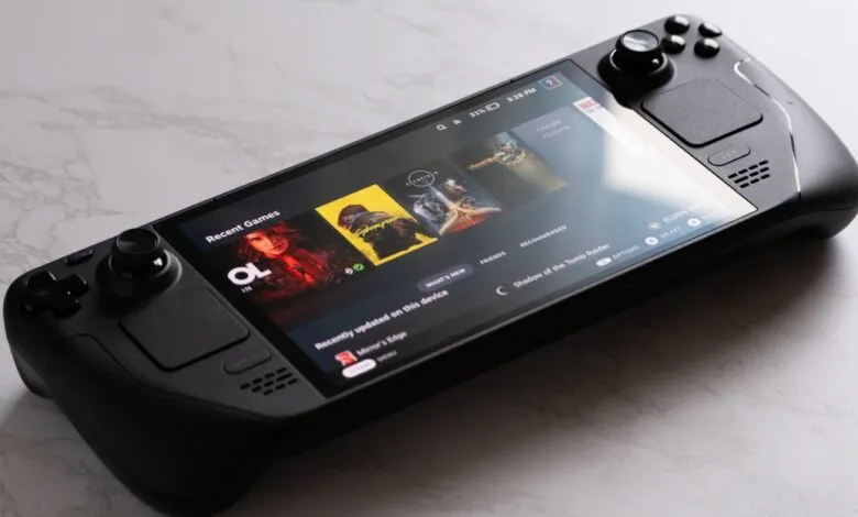 Close-up of a black handheld gaming PC displaying a game library.