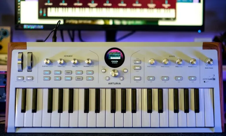 Arturia Astrolab 37 synthesizer with wooden accents and a screen displaying sound settings.