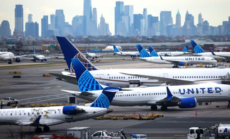 United Airlines airplanes parked on the tarmac with a city skyline in the background.