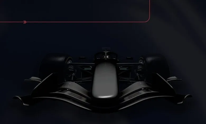 Sleek black Formula 1 race car front view on a dark background.