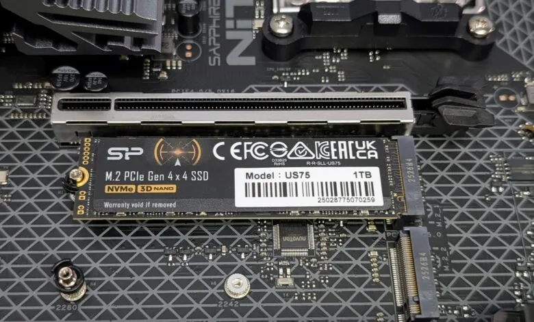 Close-up of a 1TB SP M.2 PCIe Gen 4x4 NVMe SSD installed on a computer motherboard.