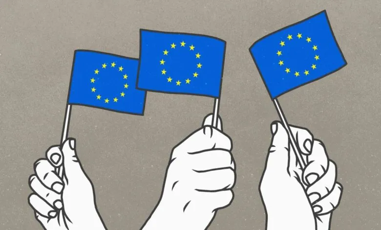 Three hands holding small European Union flags against a textured gray background.