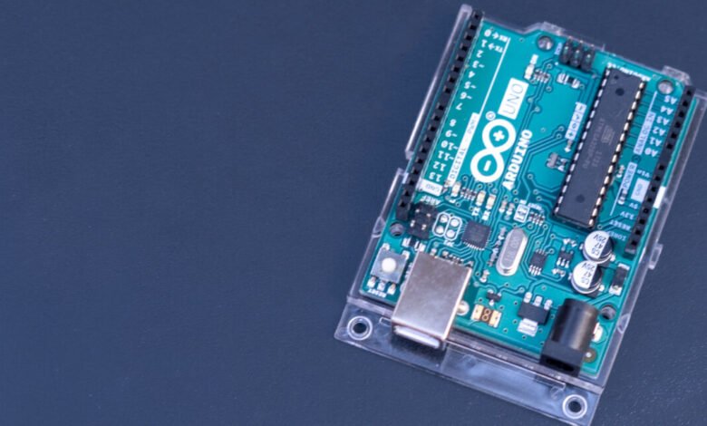 Close-up of an Arduino UNO microcontroller board with a clear protective case.