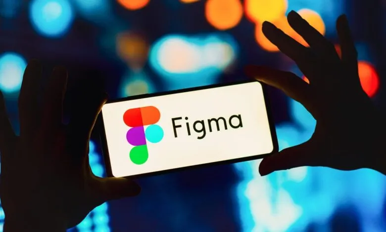 Hands holding a smartphone displaying the Figma logo and name.