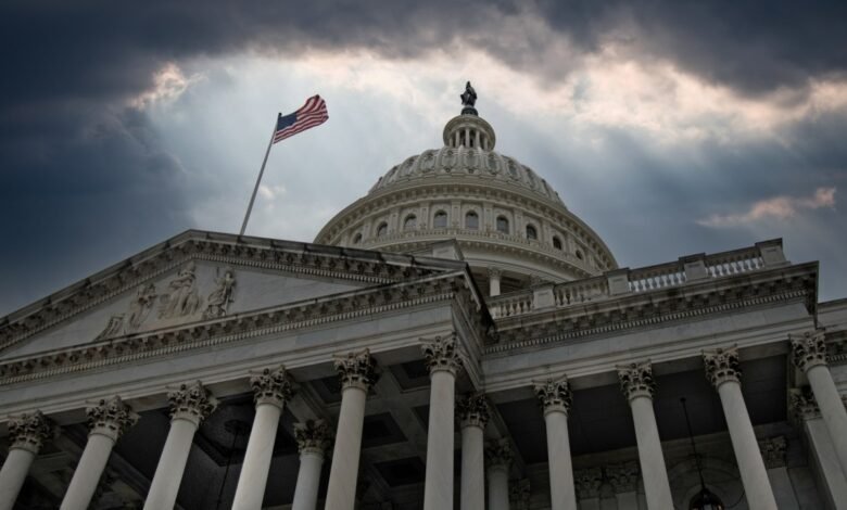 The United States Capitol Building dome and facade under a dramatic, cloudy sky.