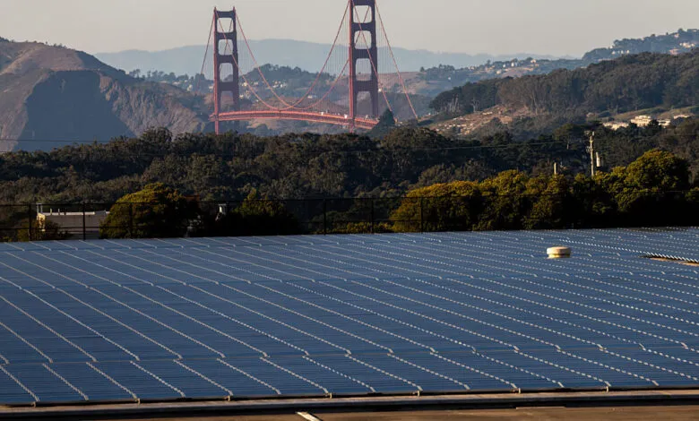 Large solar panel array with the Golden Gate Bridge in the background.