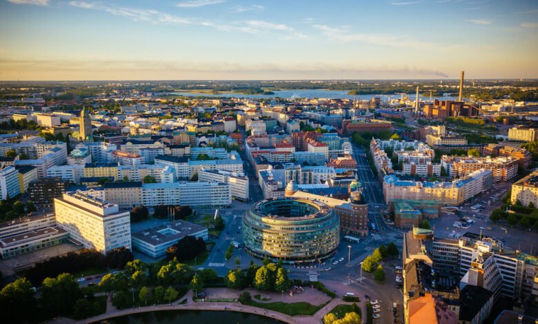 Aerial view of Helsinki cityscape at sunset, showcasing buildings and waterways.