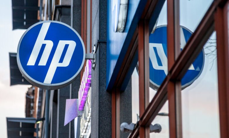 HP logo sign on a building, blue circle with white letters.