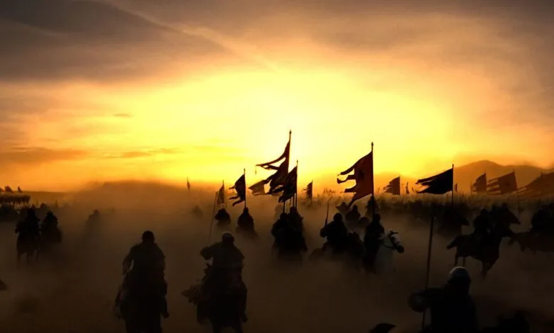 A vast army on horseback rides through a dusty landscape under a dramatic, fiery sunset.