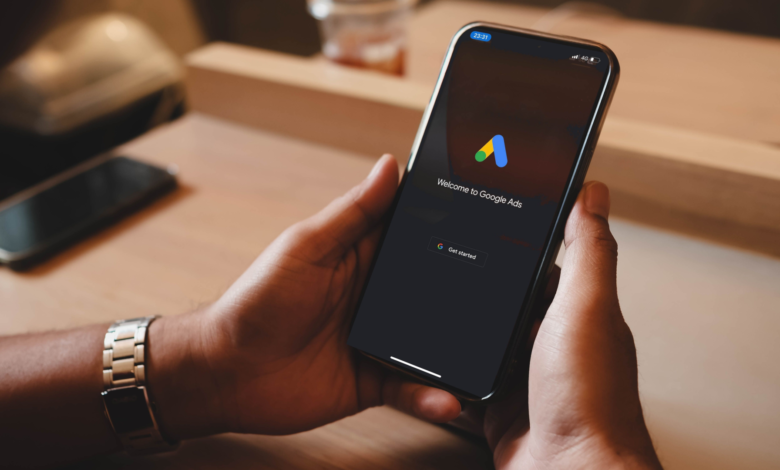 Person holding a smartphone displaying the Google Ads welcome screen.