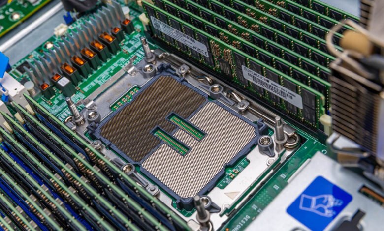 Close-up of a server motherboard with CPU socket and multiple RAM modules installed.