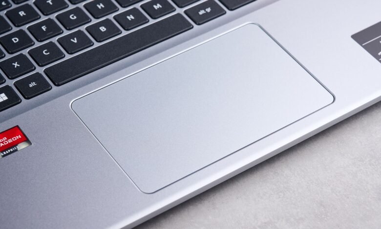 Close-up of a silver laptop keyboard and touchpad with AMD Radeon graphics logo.