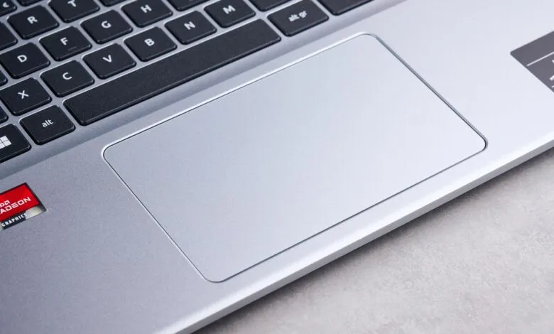 Close-up of a silver laptop keyboard and touchpad with AMD Radeon graphics logo.